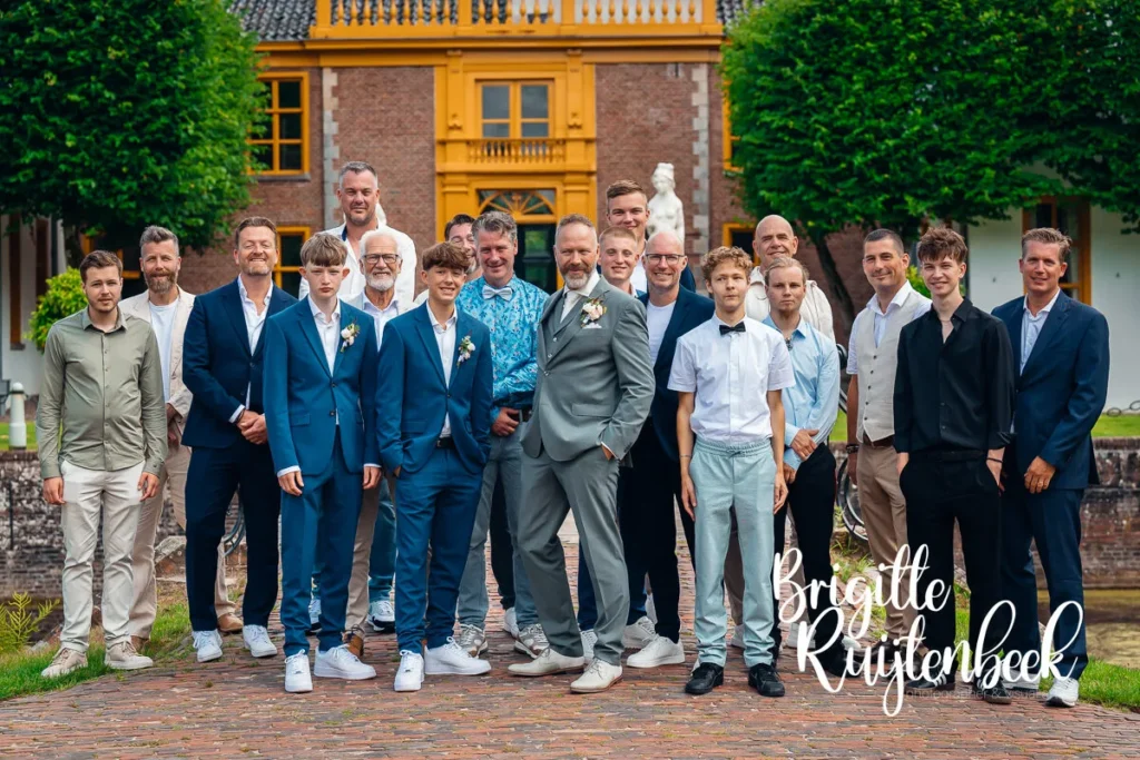 Groepsfoto van bruidegom met mannelijke gasten voor Restaurant de Boerderij naast de Fraeylemaborg in Slochteren.